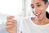 Woman holding pregnancy test