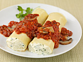 Manicotti filled with ricotta with a tomato and mushroom sauce