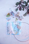 Weltkarte, Draht und Federn für selbstgemachte Weihnachtsdeko mit Friedensmotiven