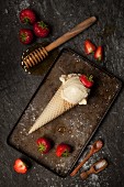 Salted Honey Ice Cream in cone with strawberries