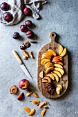 Peach, nectarine and plum wedges on a wooden chopping board