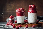 Chia pudding with raspberry and avocado mousse in glass jars