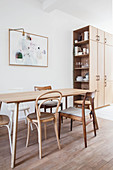 Various wooden chairs around simple dining table