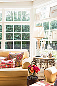 Yellow upholstered furniture with ethnic cushions in the sunny bay window