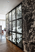 Zwischenwand mit schwarz-weißer Fototapete und Fensterrahmen in offenem Wohnraum
