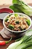 Rice noodles with beef, broccoli and pak choi (China)