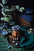 Chocolate dessert with blueberries and blue sugar pearls