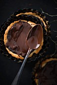 Vegan poppy seed tartlets with dark chocolate glazing