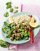 Lamb with baby spinach, lemon and spring onions served with orzo pasta