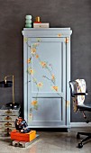 Grey cupboard painted with floral ornaments in study