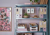 Decoupaged and painted filing system on metal shelves