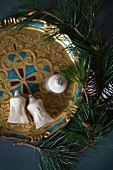 Fir branch and old Christmas-tree baubles on tray