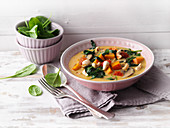 Vegan spinach and pumpkin curry with coconut milk and cashew nuts