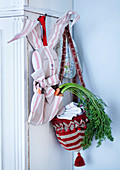 Carrots in hand-made, bunny-shaped cloth bag and basket made from bobble hat