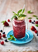 A mixed berry smoothie with mint and lemon