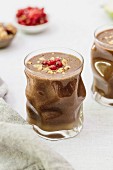 Chocolate smoothies in glasses with chopped hazelnuts on the top