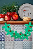 Paper holly garland with bead berries