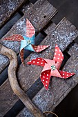 Patterned paper windmills on weathered wooden boards