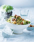 Spicy bulgur salad with sprouts, celery, apple, herb dressing and honey almonds