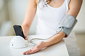 Woman taking her blood pressure