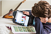 Teenage boy using Facebook on a digital tablet