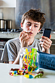 Teenage boy eating sweets