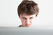 Teenage boy using laptop computer