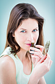 Woman smelling a bottle of essential oil