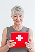 Senior woman holding a medicine box