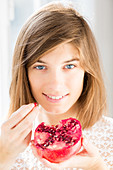 Woman eating pomegranate