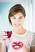 Woman drinking pomegranate juice