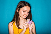 Teenage girl holding oral contraception pills