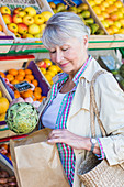 Senior woman buying fruits and vegetables
