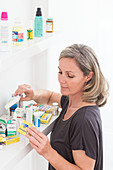Woman sorting old medicines