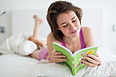 Woman reading in bed