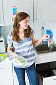 Woman throwing food in the trash