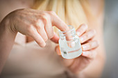 Woman disinfecting her finger with antiseptic