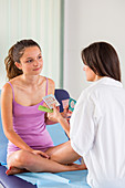 Doctor discussing oral contraception with a teenage girl