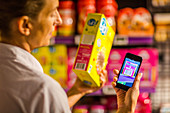 Woman using a smartphone in supermarket