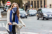 Woman riding a bicycle in a urban environment