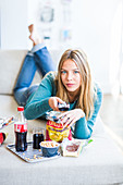 Woman snacking while watching TV