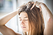 Woman massaging her scalp