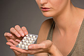 Woman taking hormone replacement pills