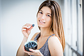 Woman eating blueberries