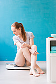 Woman sitting on scales