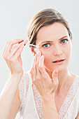 Woman using serum eye contour