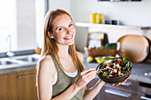 Woman eating a Mediterranean salad