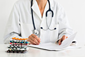 Doctor writing a medical prescription