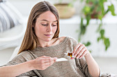 Woman applying essential oil on a tissue