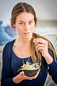 Woman eating soybean sprouts